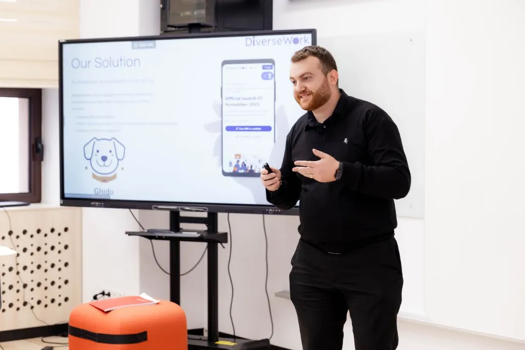 Ionuț-Iacob Cotoi prezintă DiverseWork: ecran cu platforma de recrutare accesibilă și mascota Ghido